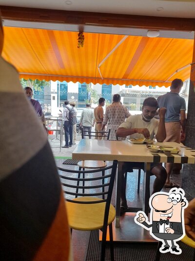 Take a seat at one of the tables at New Prakash Cafe