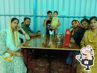 Take a seat at one of the tables at Rudra Restaurant