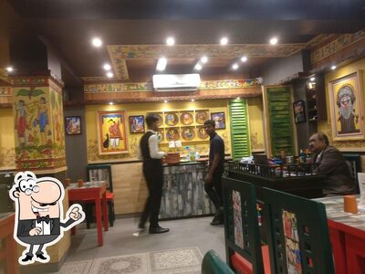 Take a seat at one of the tables at Saptapadi Restaurant Puri