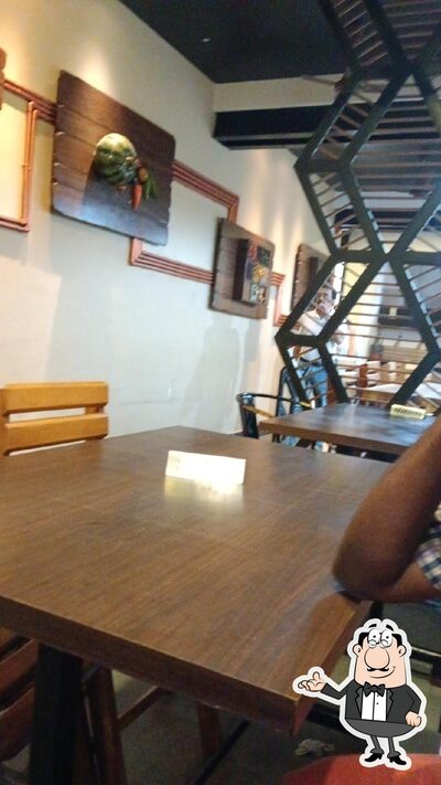 Take a seat at one of the tables at Vinayaka hotel