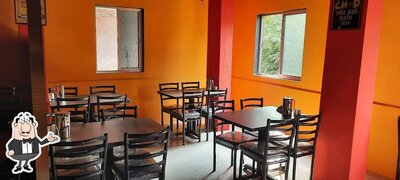 Take a seat at one of the tables at ENJOY BAR AND RESTAURANT