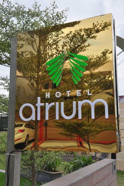 The advertisement shows information about Hotel Atrium Erode