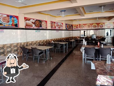 Take a seat at one of the tables at Handi Restaurant