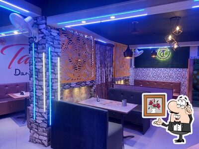 Take a seat at one of the tables at Tasty chicken Corner and Tasty Darbar family hotel