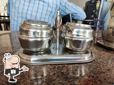 Take a seat at one of the tables at அன்னபூர்ணா மெஸ் ( நந்திதா கேட்டரிங் சர்வீஸ்)