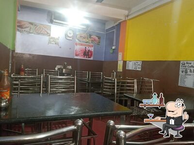 Take a seat at one of the tables at Navin Fast Food Restaurants
