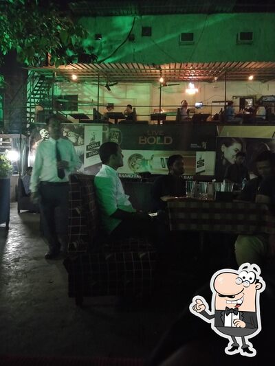 Take a seat at one of the tables at Hotel Nityanand Family Restaurant