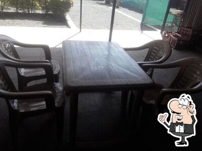 Take a seat at one of the tables at Hotel New Ranwara