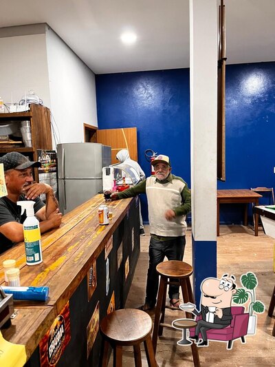 Sente em uma das mesas no Ricardo Bar e Conveniência