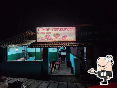 Take a seat at one of the tables at Omkar Restaurant