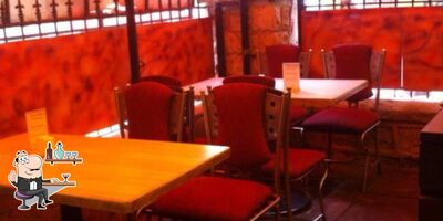 Take a seat at one of the tables at Spice Up Veg Restaurant