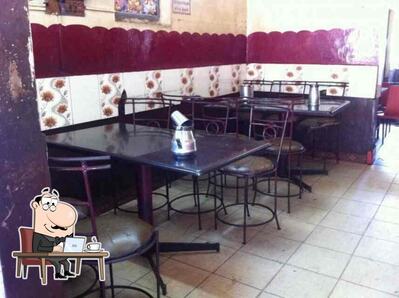 Take a seat at one of the tables at Hotel Rusy