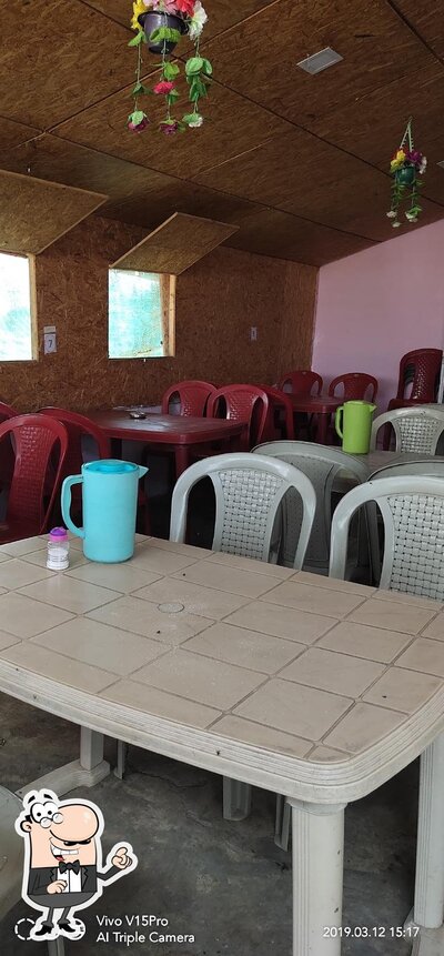 Take a seat at one of the tables at Ekvira Hotel