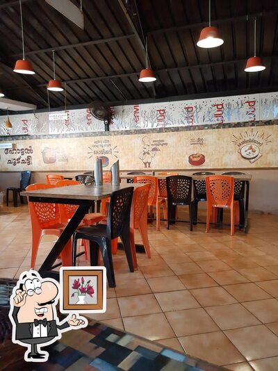 Take a seat at one of the tables at Hot Pot Restaurent (shab) naimarmoola