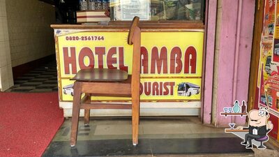 Take a seat at one of the tables at Hotel Amba
