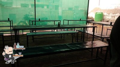 Take a seat at one of the tables at Choudhary Mess & Tiffin Center