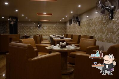 Take a seat at one of the tables at Purnima Restaurant