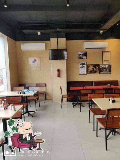 Take a seat at one of the tables at Dominos Pizza