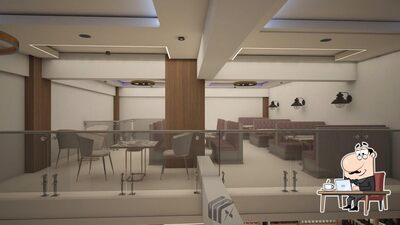 Take a seat at one of the tables at Sakshi Restaurant And Bar
