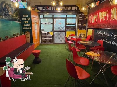 Take a seat at one of the tables at Shawarma Hut