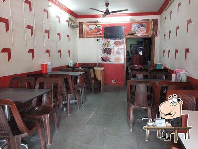 Take a seat at one of the tables at EVEREST FAST FOOD CENTER