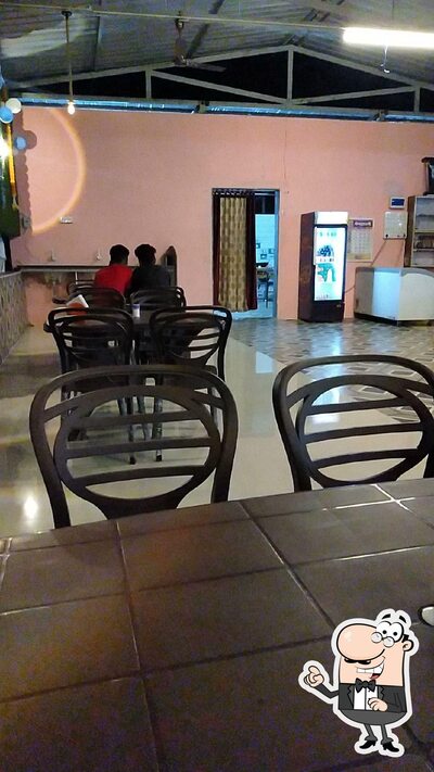 Take a seat at one of the tables at Hotel Omkar Family Daba