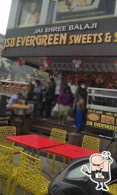 Take a seat at one of the tables at JSB Evergreen Sweets Noida