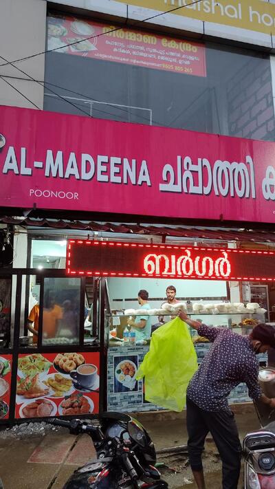 The advertisement shows information about Al- Madheena Chappathi Company poonoor
