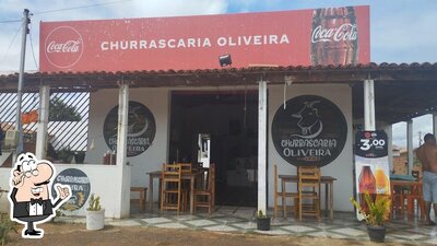 Sente em uma das mesas no Churrascaria Oliveira