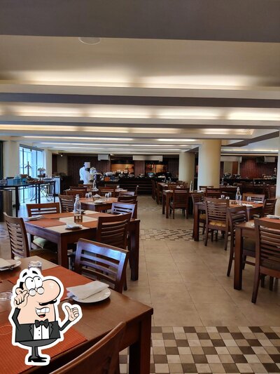 Take a seat at one of the tables at Laranja - Taj Cidade de Goa Heritage, Goa