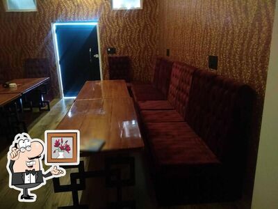 Take a seat at one of the tables at R R Hotel & Restaurant