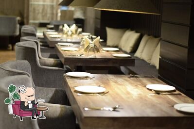 Take a seat at one of the tables at Aranya's Pure Veg Restaurant