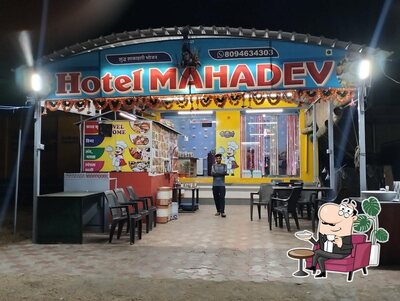 Take a seat at one of the tables at Hotel mahadev