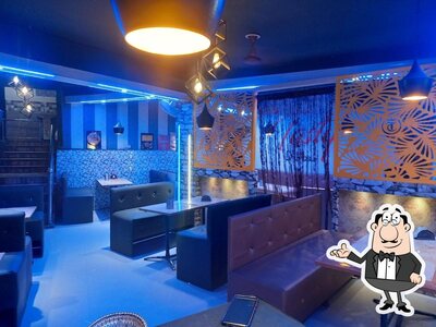 Take a seat at one of the tables at Tasty chicken Corner and Tasty Darbar family hotel