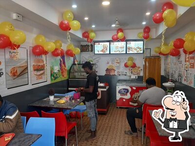 Take a seat at one of the tables at Five star Chicken