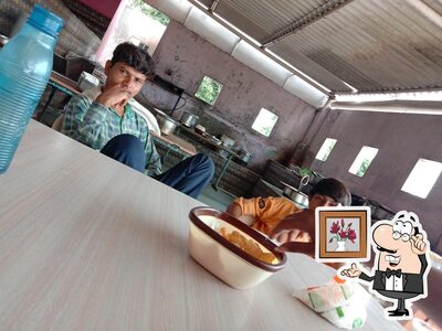 Take a seat at one of the tables at M.K. Mevada Hotel