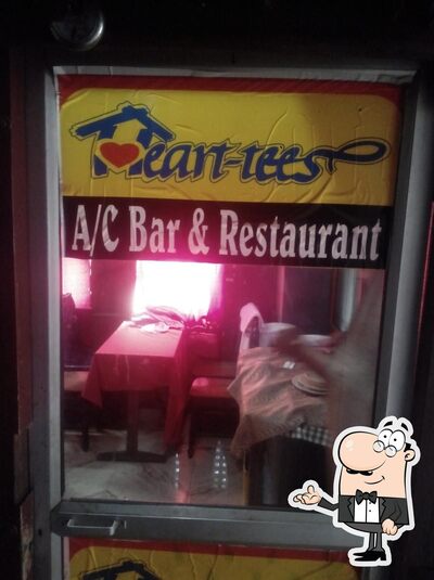 Take a seat at one of the tables at Heart Tees Bar And Restaurant
