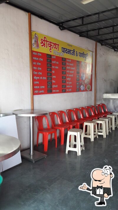 Take a seat at one of the tables at New Krishna Bhojanalay & Idli Centre