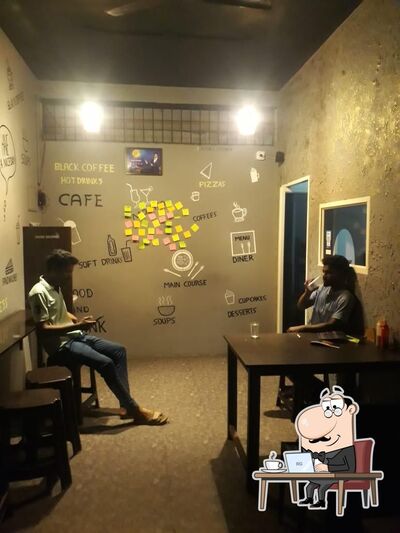 Take a seat at one of the tables at Ayaaf's Kitchen - Cafe in Adyar, Mangalore