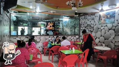 Take a seat at one of the tables at BHUKKAD FULLY AC RESTORANT