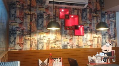 Take a seat at one of the tables at TYM PASS THE CAFE