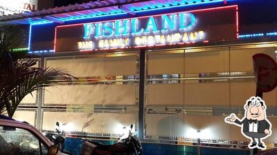 Take a seat at one of the tables at Fishland Restaurant