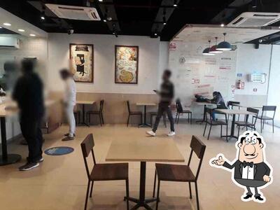 Take a seat at one of the tables at Domino's Pizza