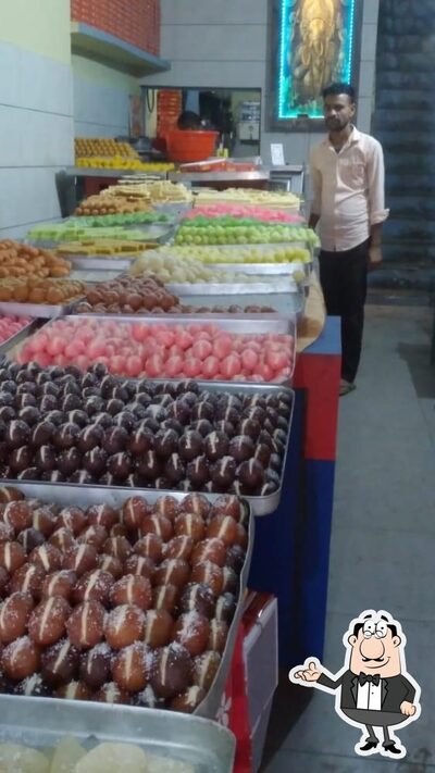 Take a seat at one of the tables at Sharma Sweets & Snacks